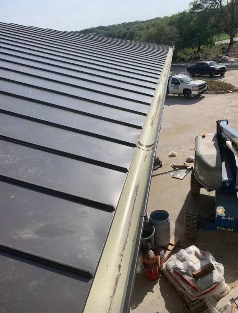 Standing seam panel and gutter detail on a metal roofing jobsite in Las Flores